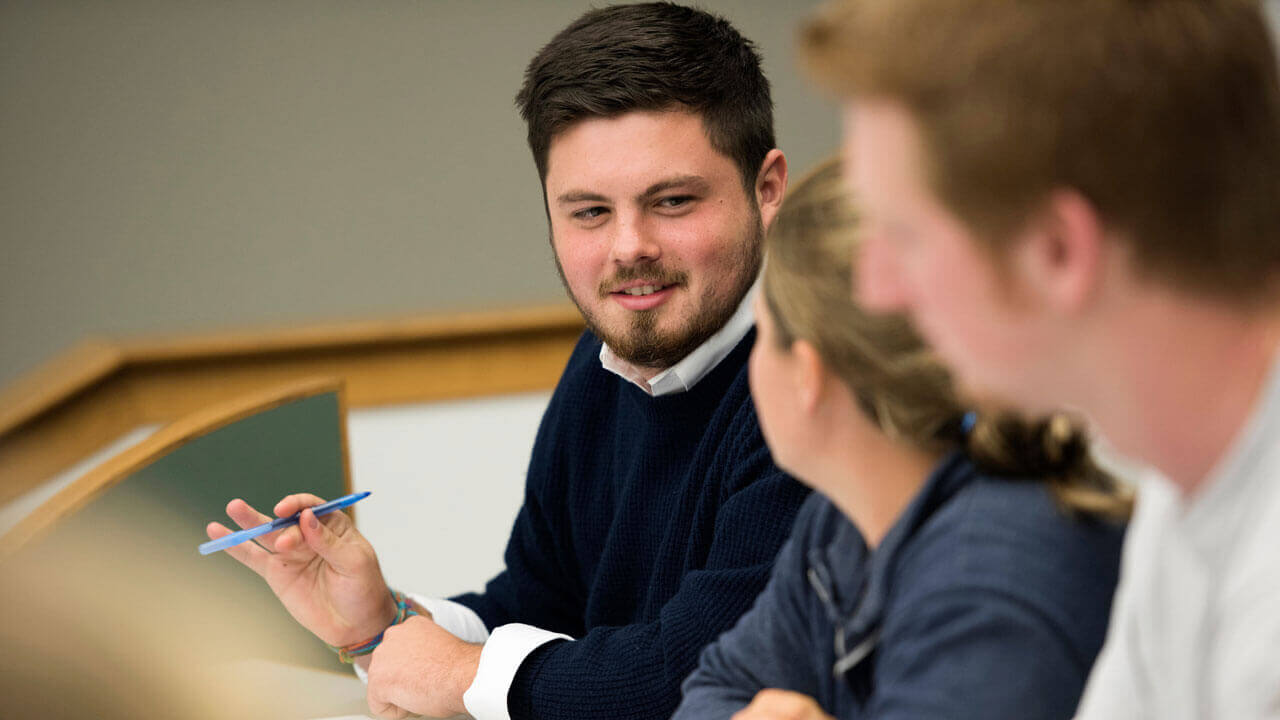 Students collaborating together in a classroom in the School of Business.