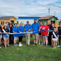 Cameron Levasseur cutting a ceremonial ribbon