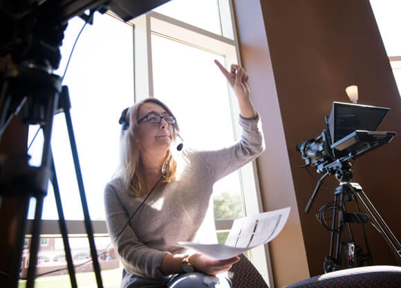 Cinematic production assistant communicating on set.