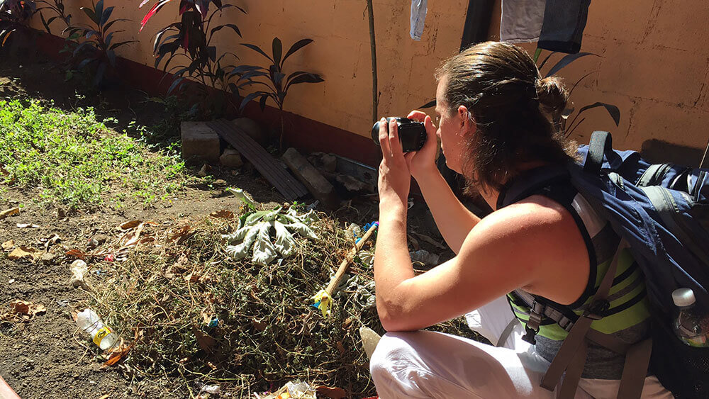 A journalism student snaps photos with her camera