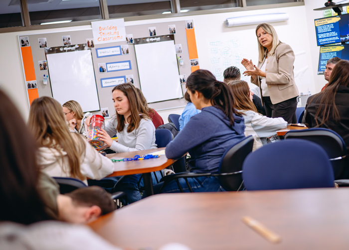 Quinnipiac education students participate in a hands-on activity in a classroom.