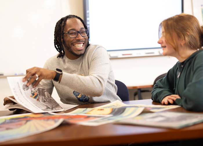 Quinnipiac graduate education student works with a young student in a classroom