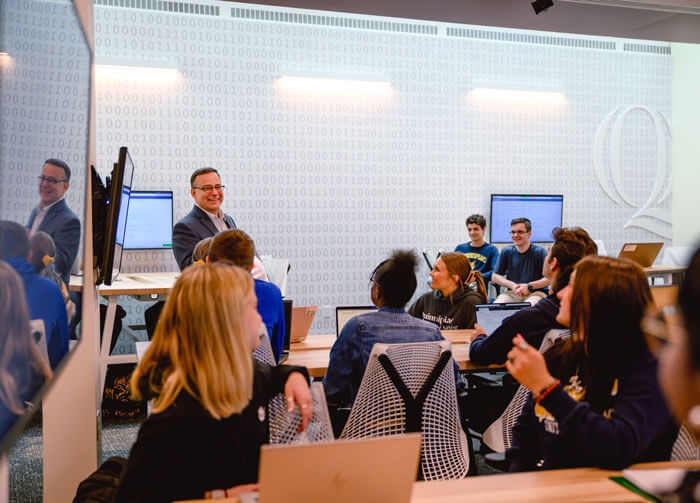 A professor instructs a computing class.