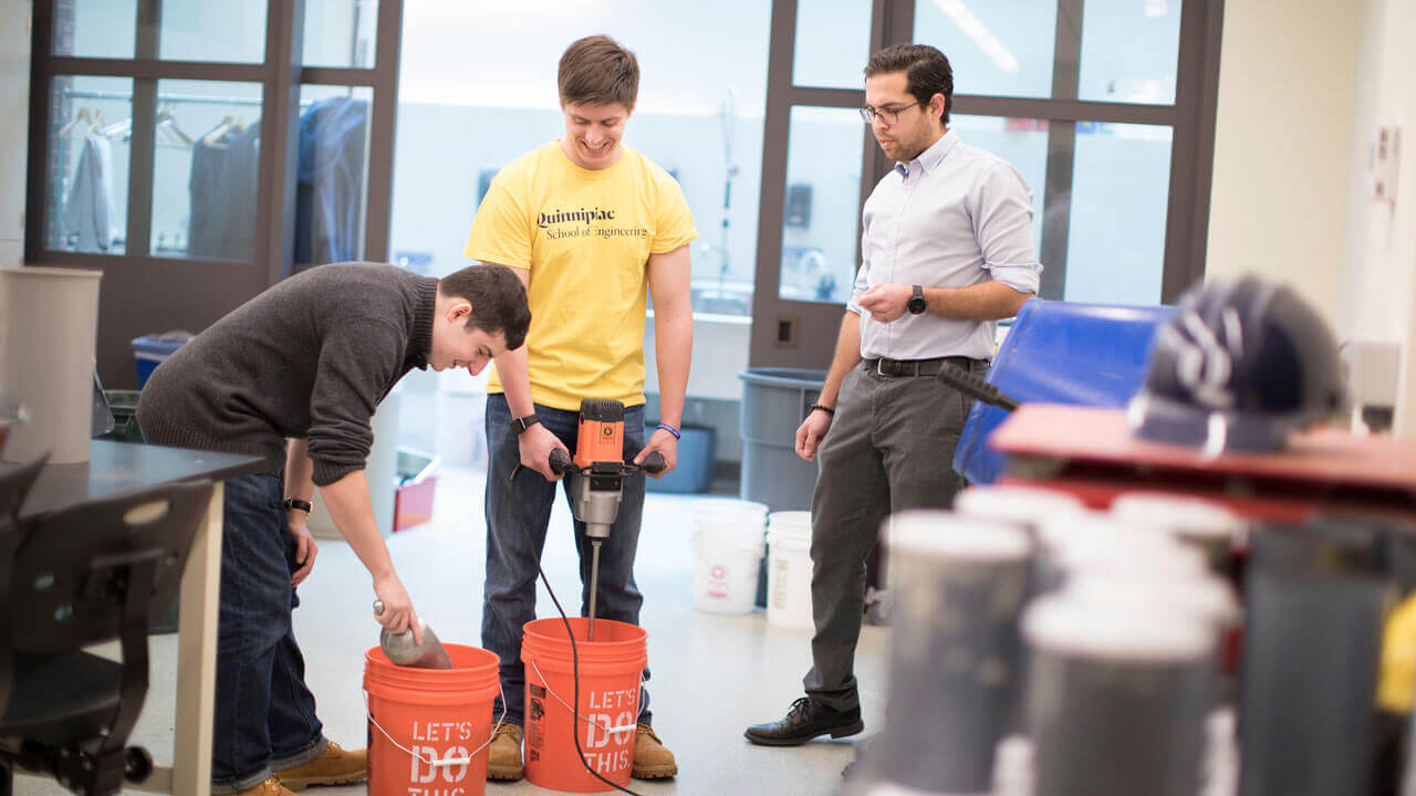 A professor and students performing compression and density tests in the School of Engineering’s environmental workshop