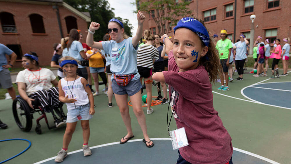 A young child with limb loss participates in a dance competition