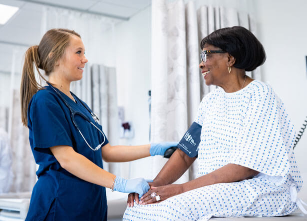 A nursing student working with a patient.