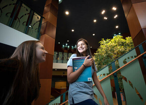 Two graduate students walk up a stairwell on the North Haven Campus