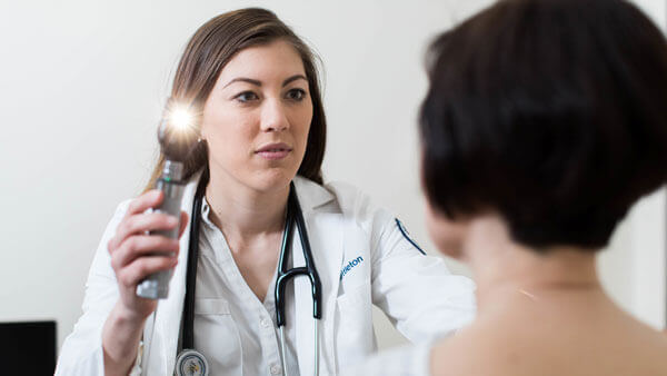 A medical student practices clinical skills with a patient actor