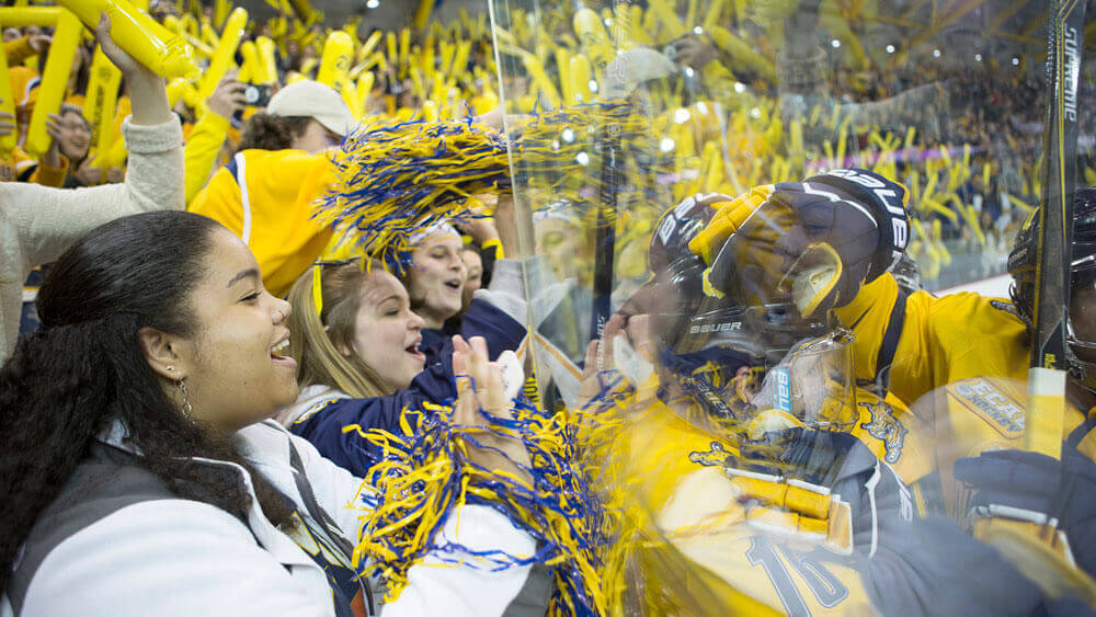 Members of #BobcatNation take a photo as they await the start of the men’s hockey game against Yale at the People’s United Center on the York Hill Campus.