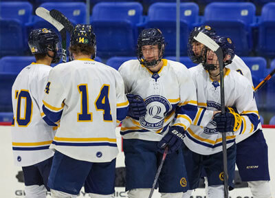 Group of men hurdled together on the ice