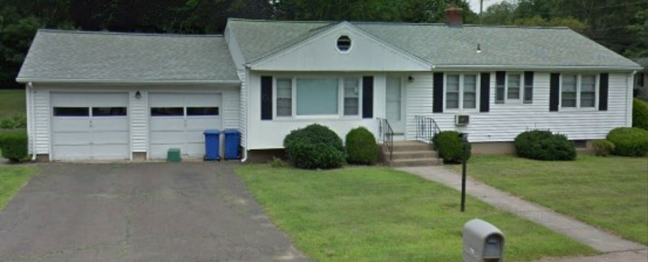 White ranch house with a 2 car garage on 114 New Road