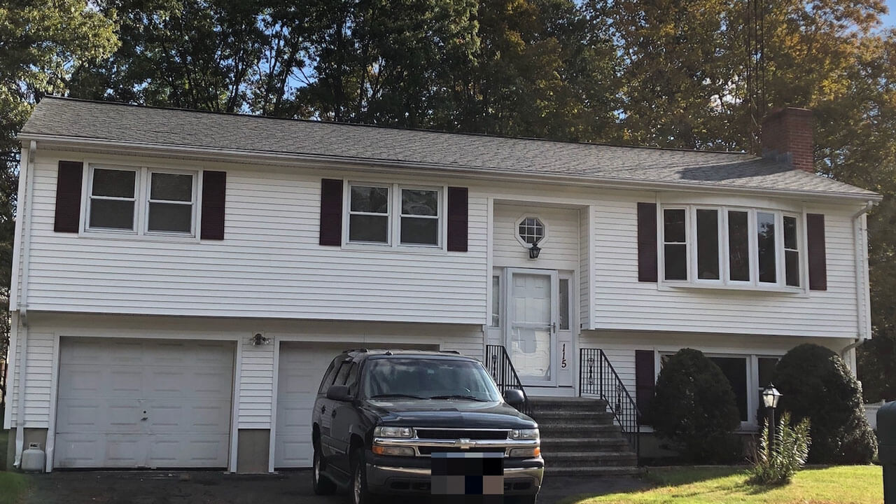 White raised ranch with one car garage on 115 Lucien Drive