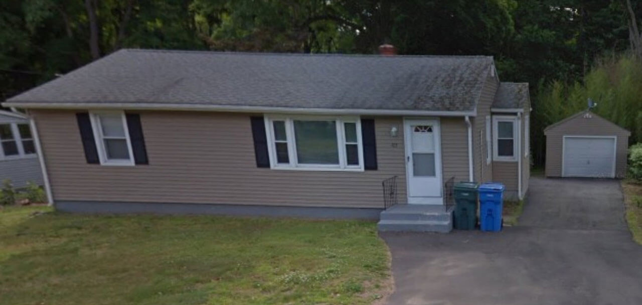 Brown ranch house with one car garage on 123 New Road