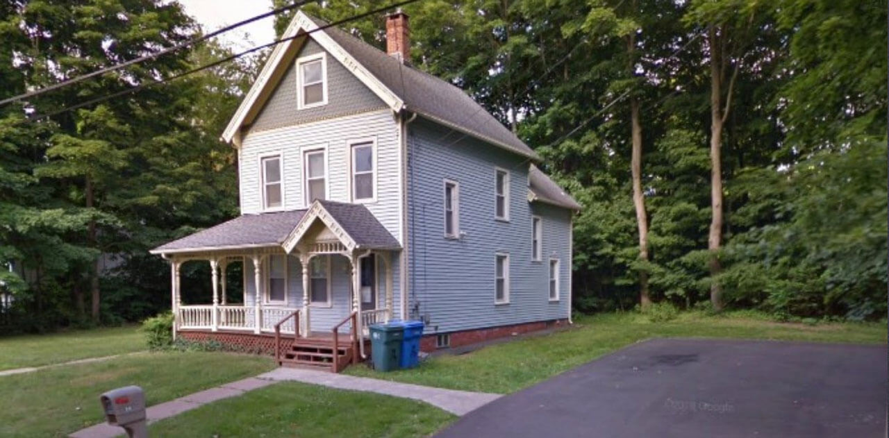 White house with a porch on 36 New Road