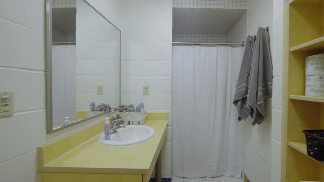 A completed bathroom with a sink, shower, and toliet