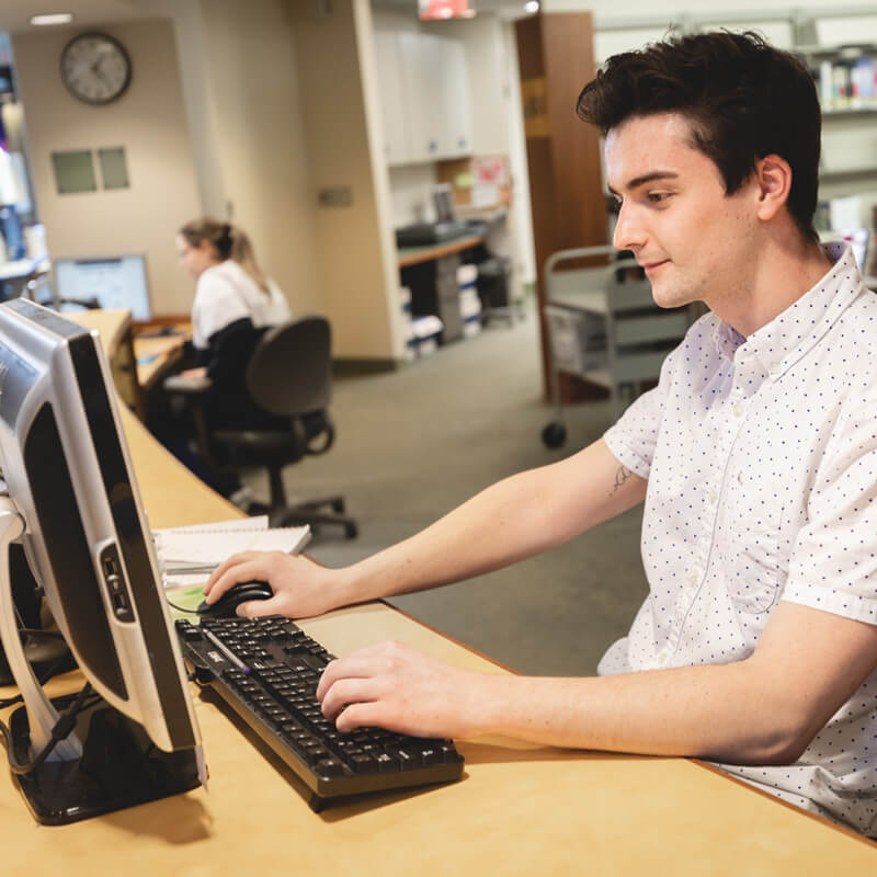 A person works at a computer in an office setting