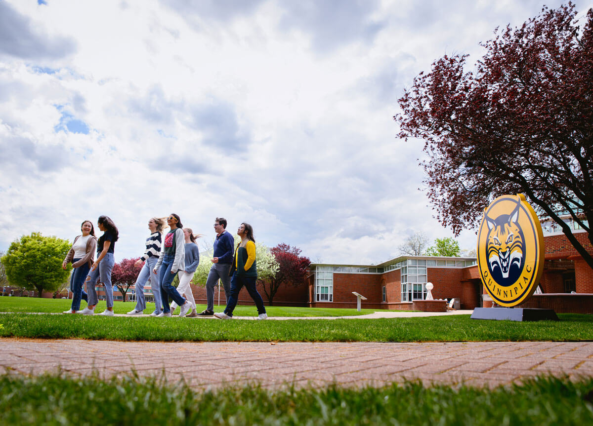 Students walking across the Mount Carmel campus quad.