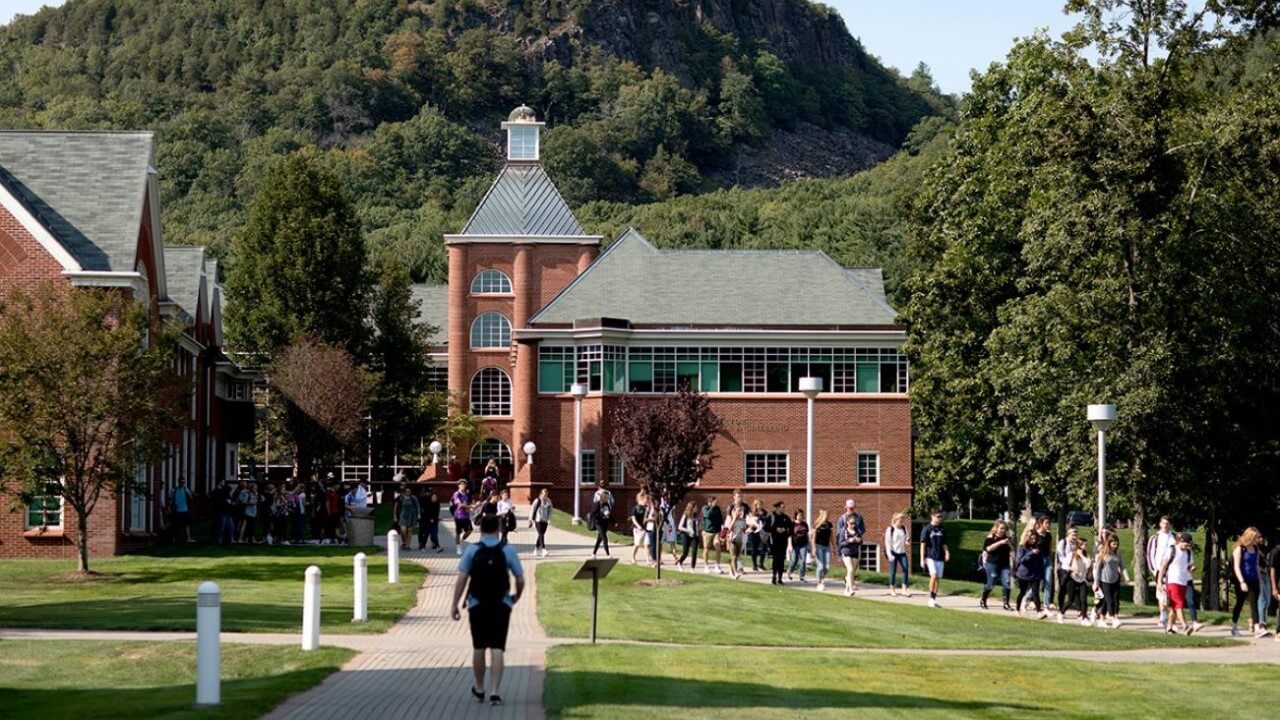 Students walk outside in front of the Center for Communications and Engineering