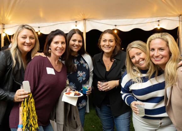 Six alumni smile for a photo during a Bobcat Weekend social