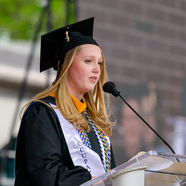 Bobbi Dynice speaks at the microphone on the library steps