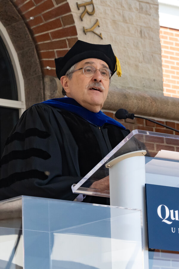 Rocco Orlando looks out into the audience from the library steps