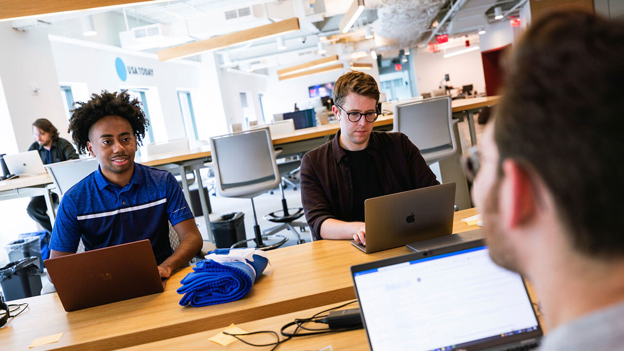 Toyloy Brown works at a computer in the USA Today office building